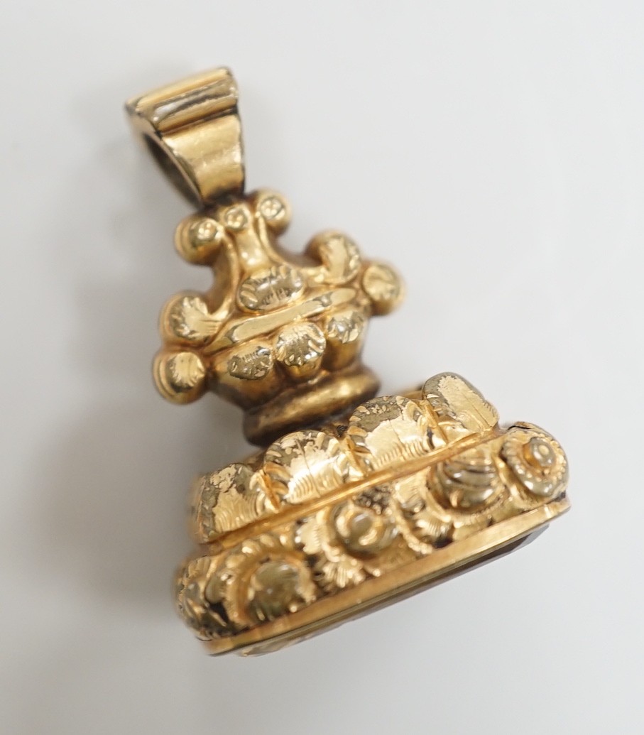 A Victorian yellow metal overlaid mounted citrine fob seal, the matrix carved with fox hunting scene, 34mm.